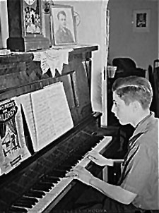 old photo of a boy at the piano