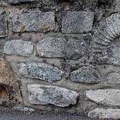 fossil inset in a stone wall